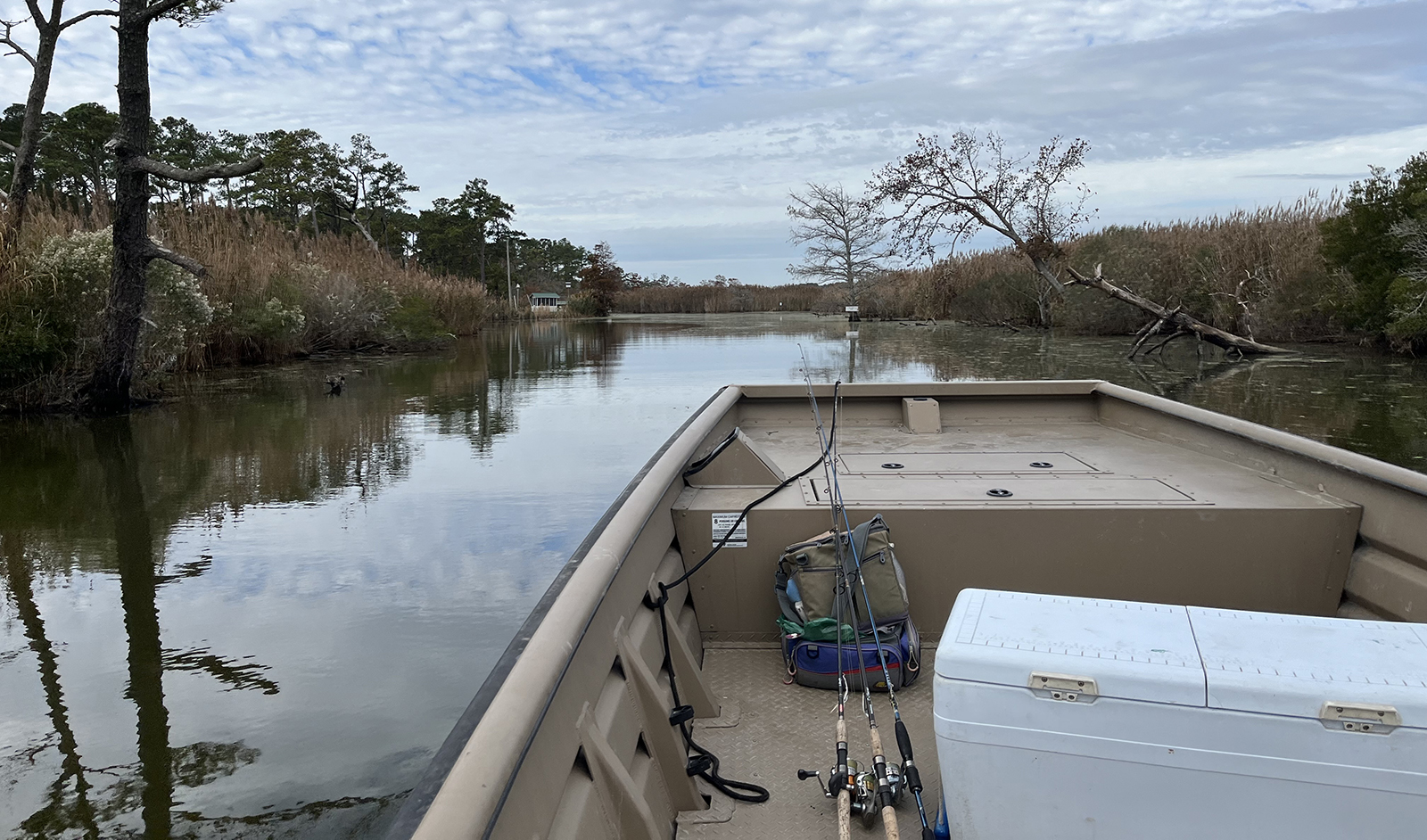 Une photo de la proue d'un bateau se faufilant dans un étroit chenal d'eau avec des marches de part et d'autre.
